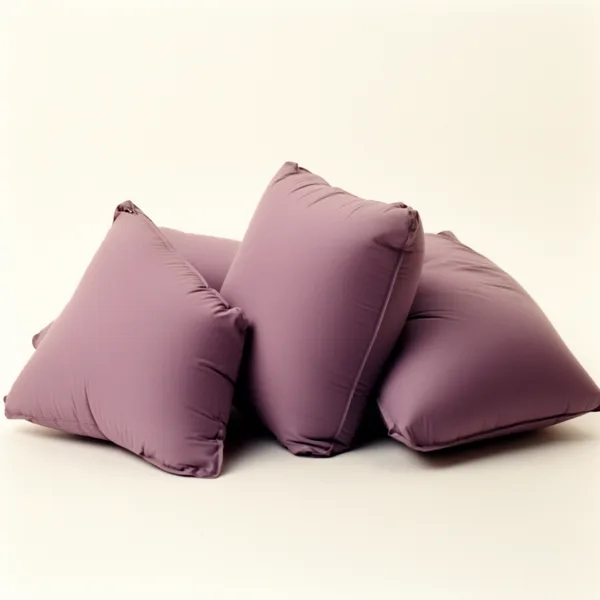 Three soft purple cushions stacked against each other on a neutral background with soft lighting.