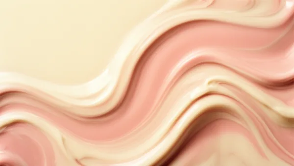 Abstract image of pink and cream swirls with smooth, wavy patterns under soft natural lighting.