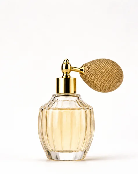 A vintage perfume bottle with a golden atomizer and a ribbed glass design on a white background.